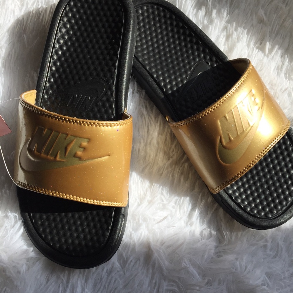 Gold Nike slides